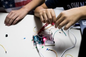 two children build a prototype circuit with a red laser