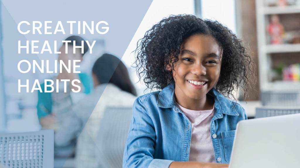 K-12 student smiling as she uses her laptop.