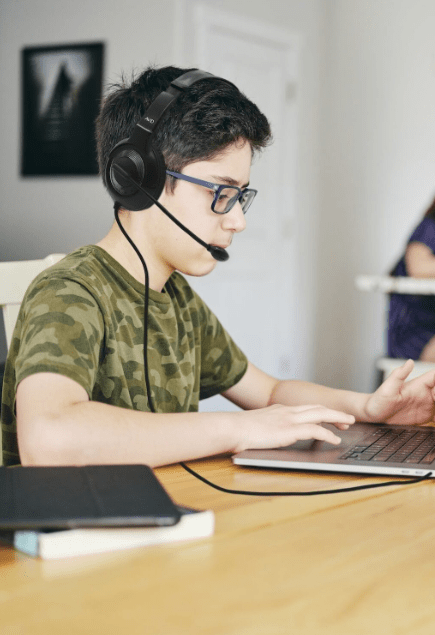 Boy using he AE-55 headset to study.