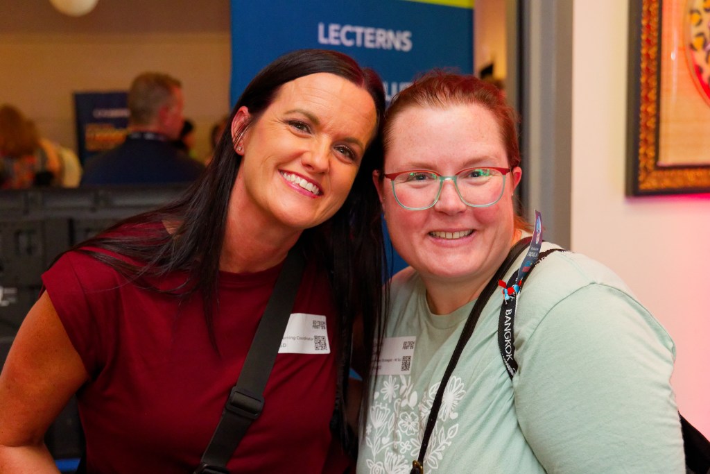 Two ladies smiling at a networking event