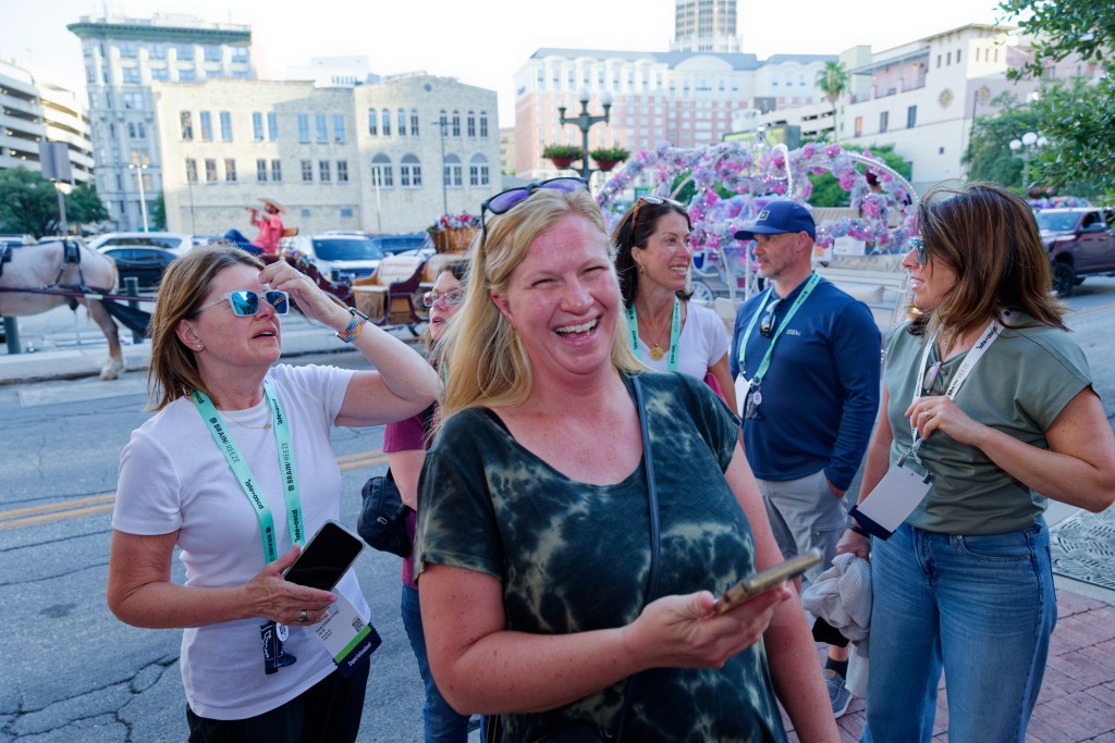 Group of people lined up for an event, one lady laughing