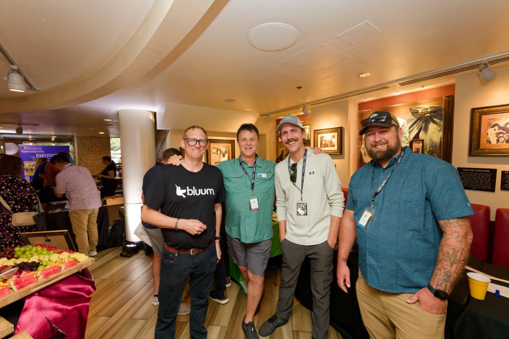 Group of men smiling at a networking event