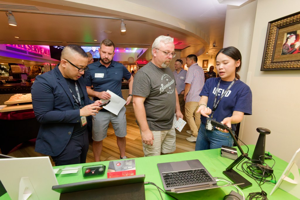 small group of people interested in a product demonstration at a networking event