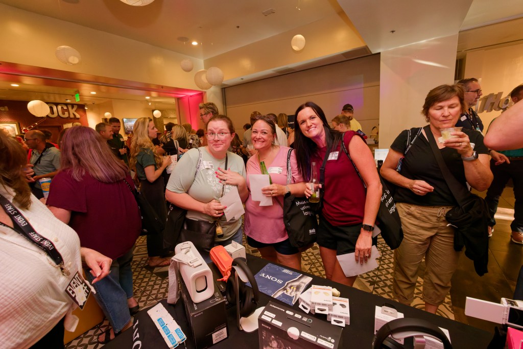 Three ladies posing for a photo at an industry event